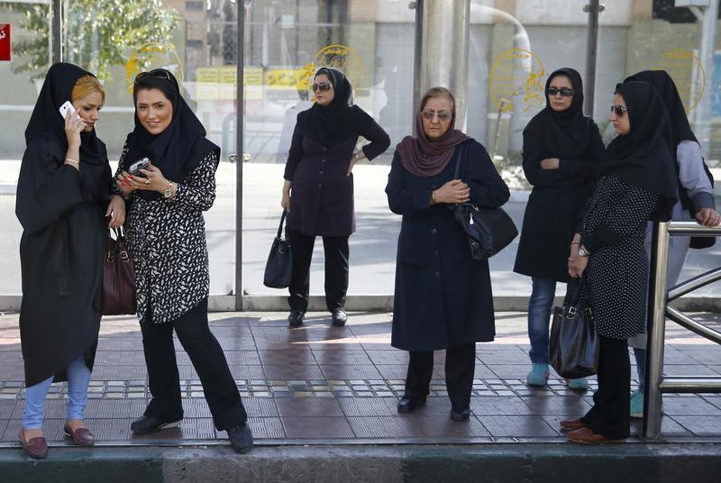 Iran women at a bus stop